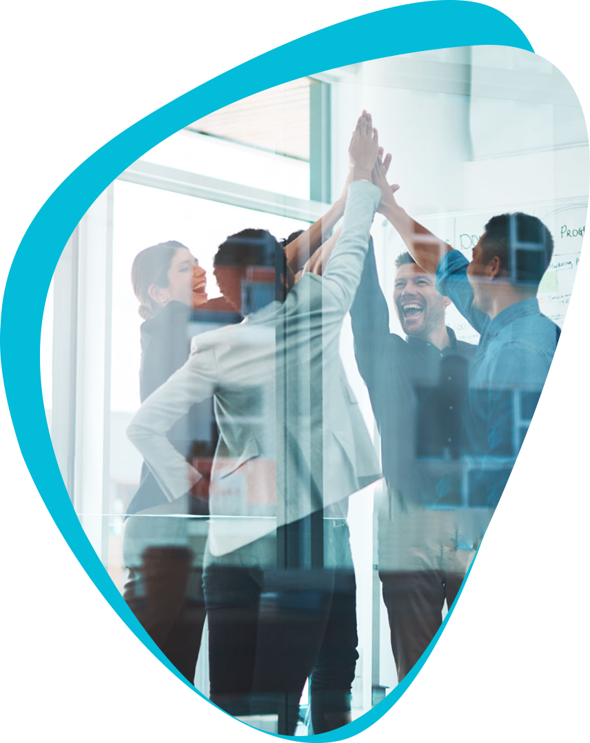 Group of people in a conference room high fiving.