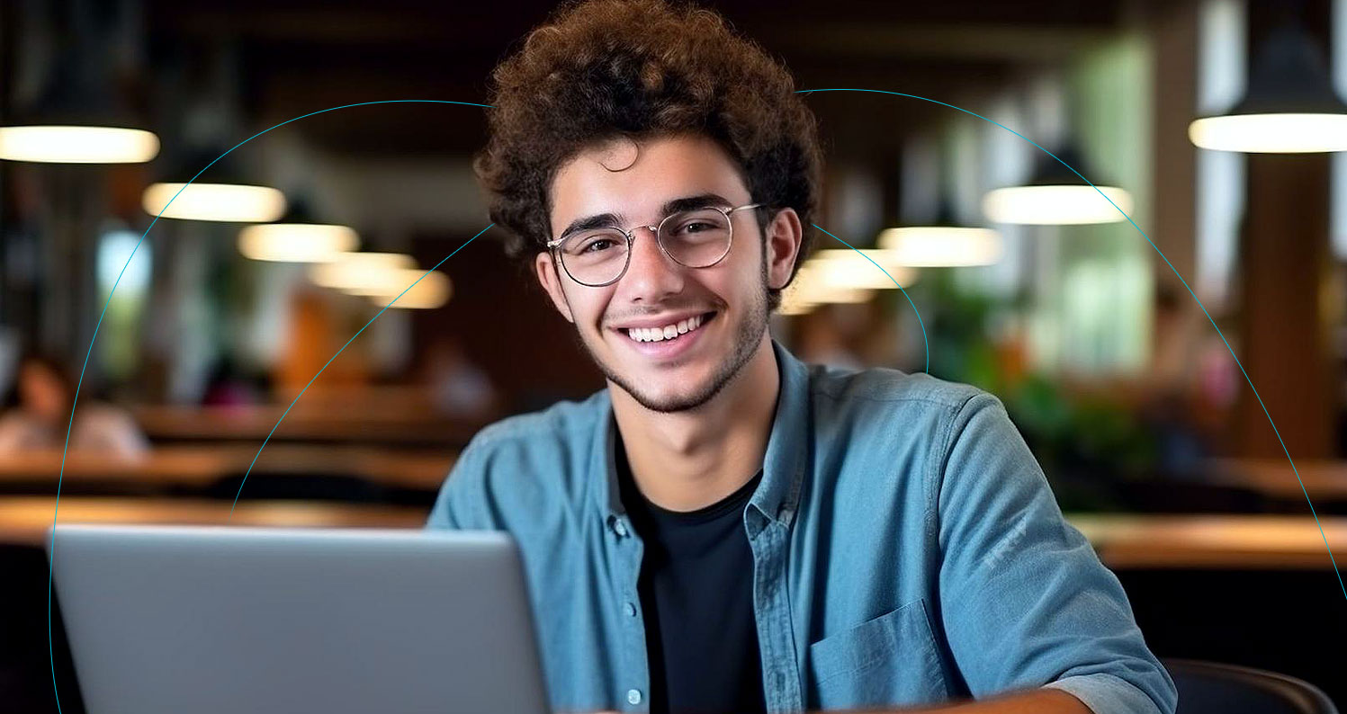 Man using his laptop smiling.