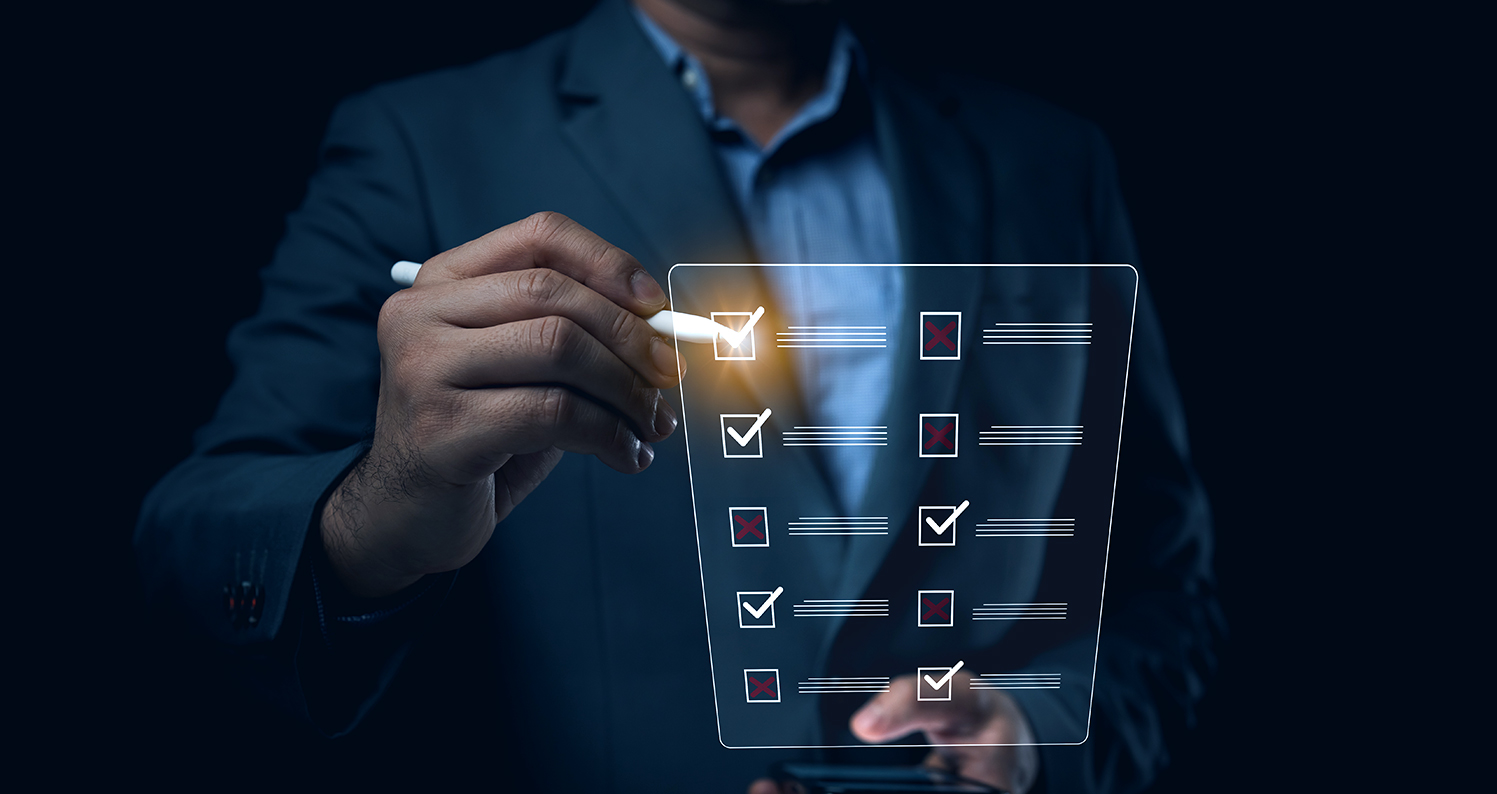 A man in a suit touching a clear panel checklist with a stylus that is lighting up at the point of contact.