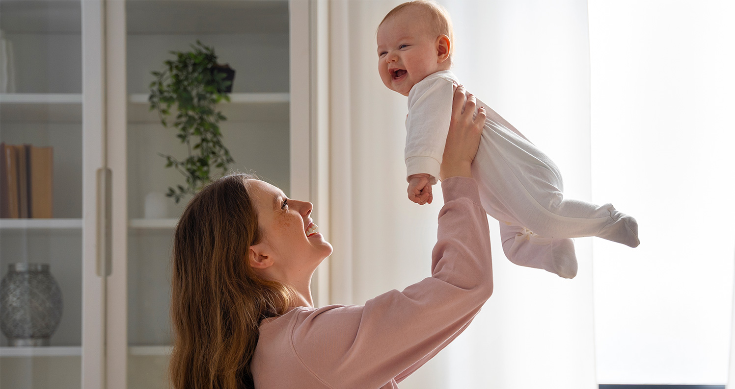 Picture of a mother playing with her baby.